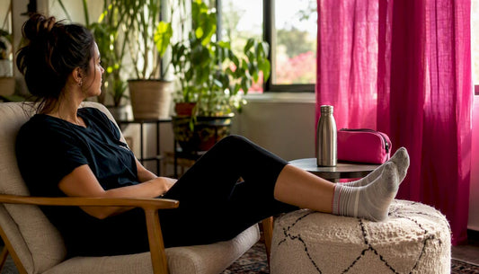 Woman elevating swollen feet at home