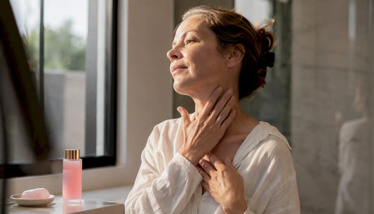 Woman applying serum to neck and hands