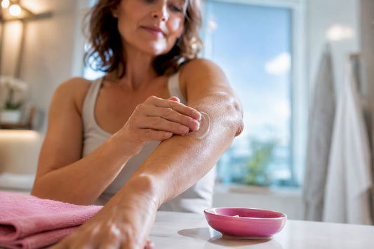 Woman applying moisturizer to itchy forearm