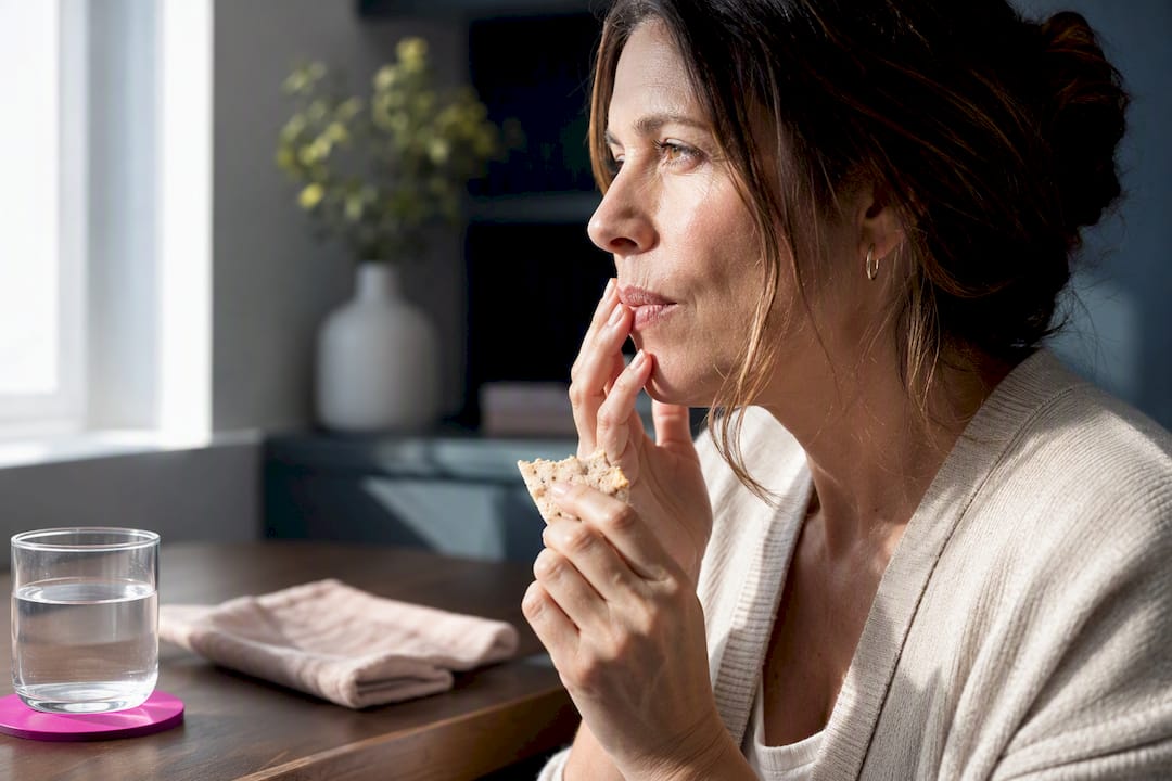 Woman experiencing dry mouth while eating